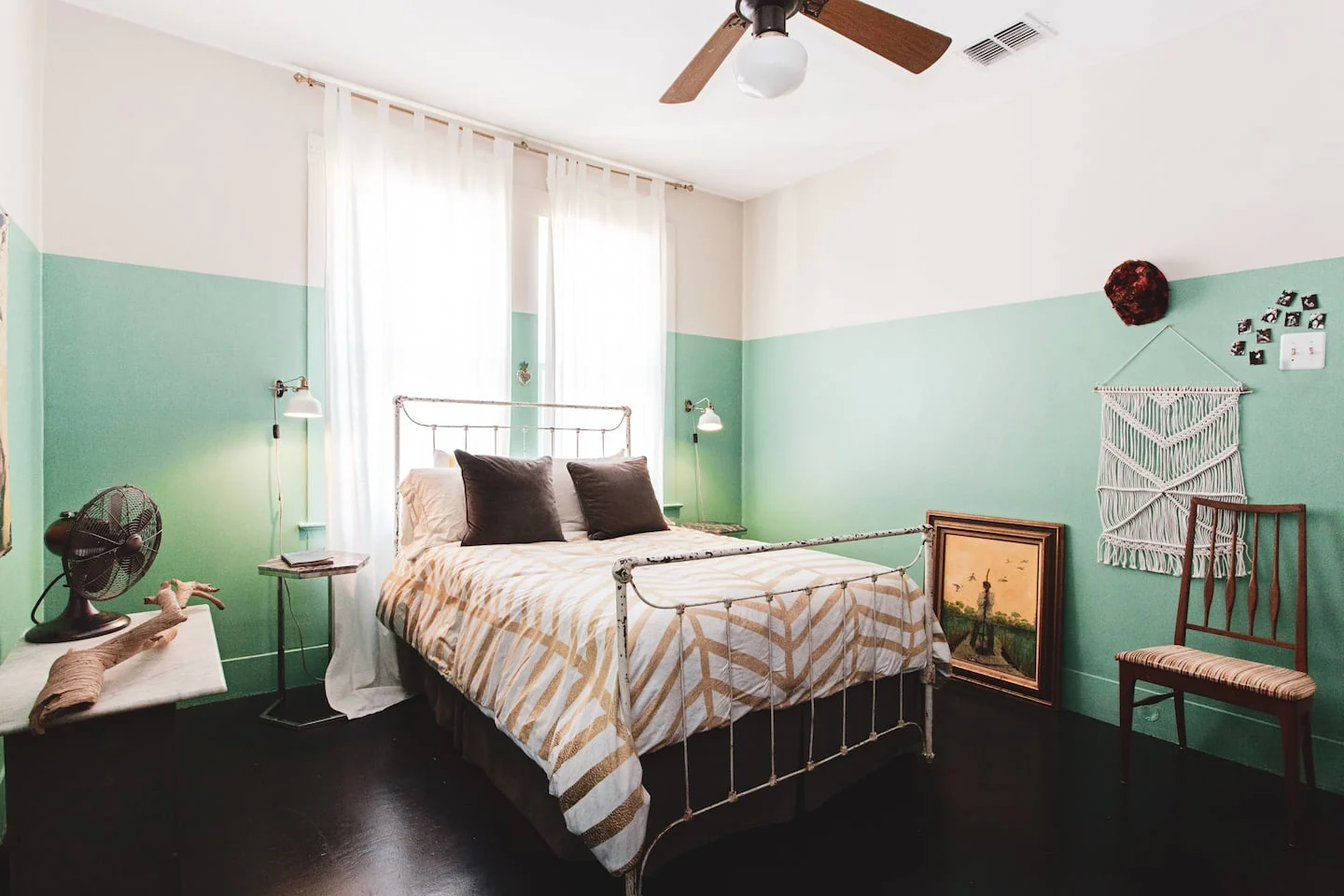 Bedroom with mint green walls and dark wood flooring — 2nd St, Austin, Texas