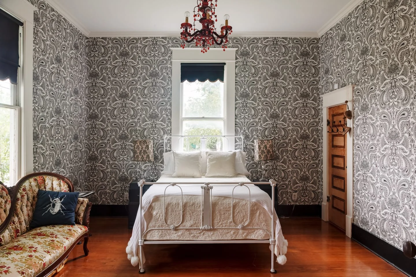 Bedroom with ornate wallpaper, a metal bed and floral vintage sofa — Navasota, Austin, Texas