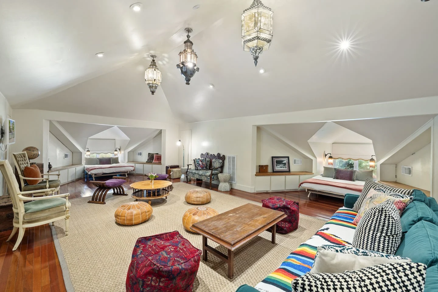 Upstairs lounge with colorful stools, patterned seating and pendant lights — Navasota, Austin