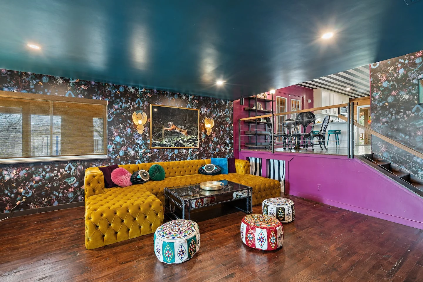 Eclectic living room with a mustard tufted sofa, dark teal ceiling and floral wallpaper — Oak Springs, Austin, Texas