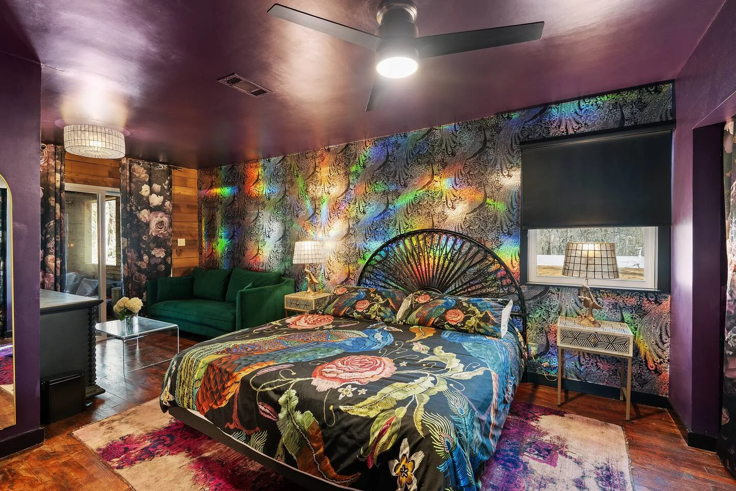 Jewel-toned bedroom with floral walls, a dark ceiling and patterned bedding — Oak Springs, Austin, Texas