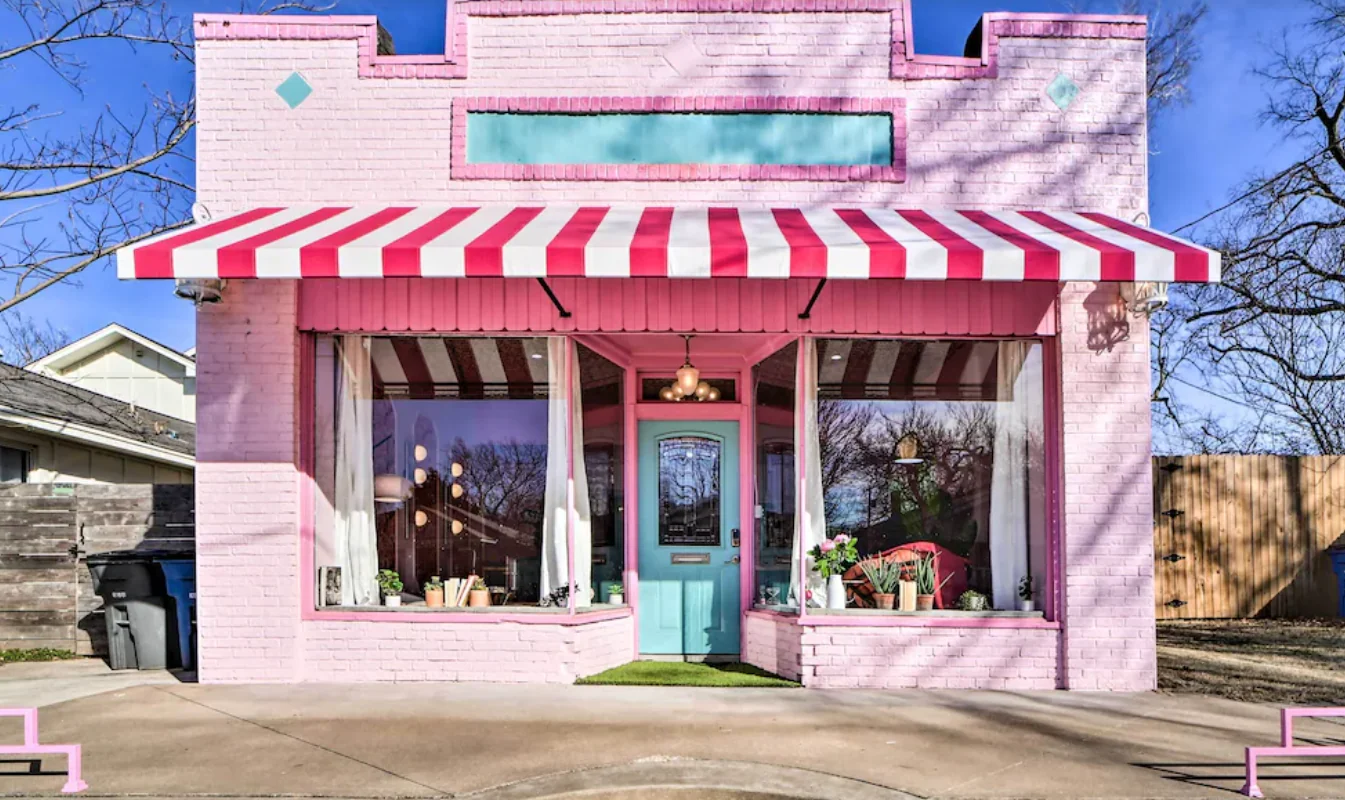 Pink storefront with a striped awning and a turquoise front door — Tulsa Birdcage, Tulsa, Oklahoma